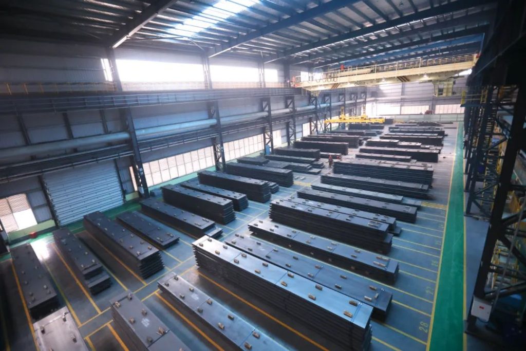 Stacks of heavy-duty steel plates stored inside LY Steel’s modern production warehouse